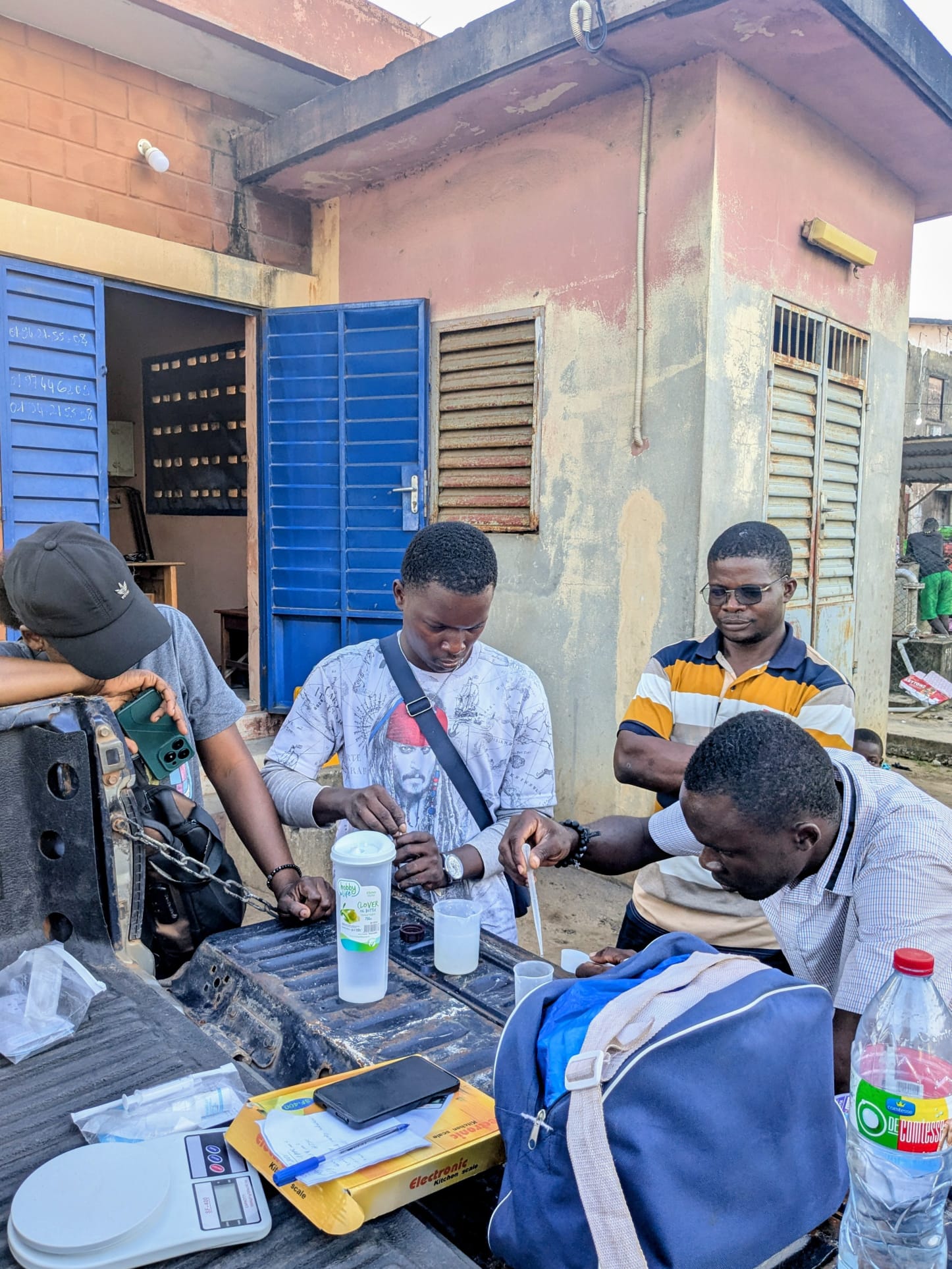 Field team measuring chlorine solution and checking water quality during a WATA intervention