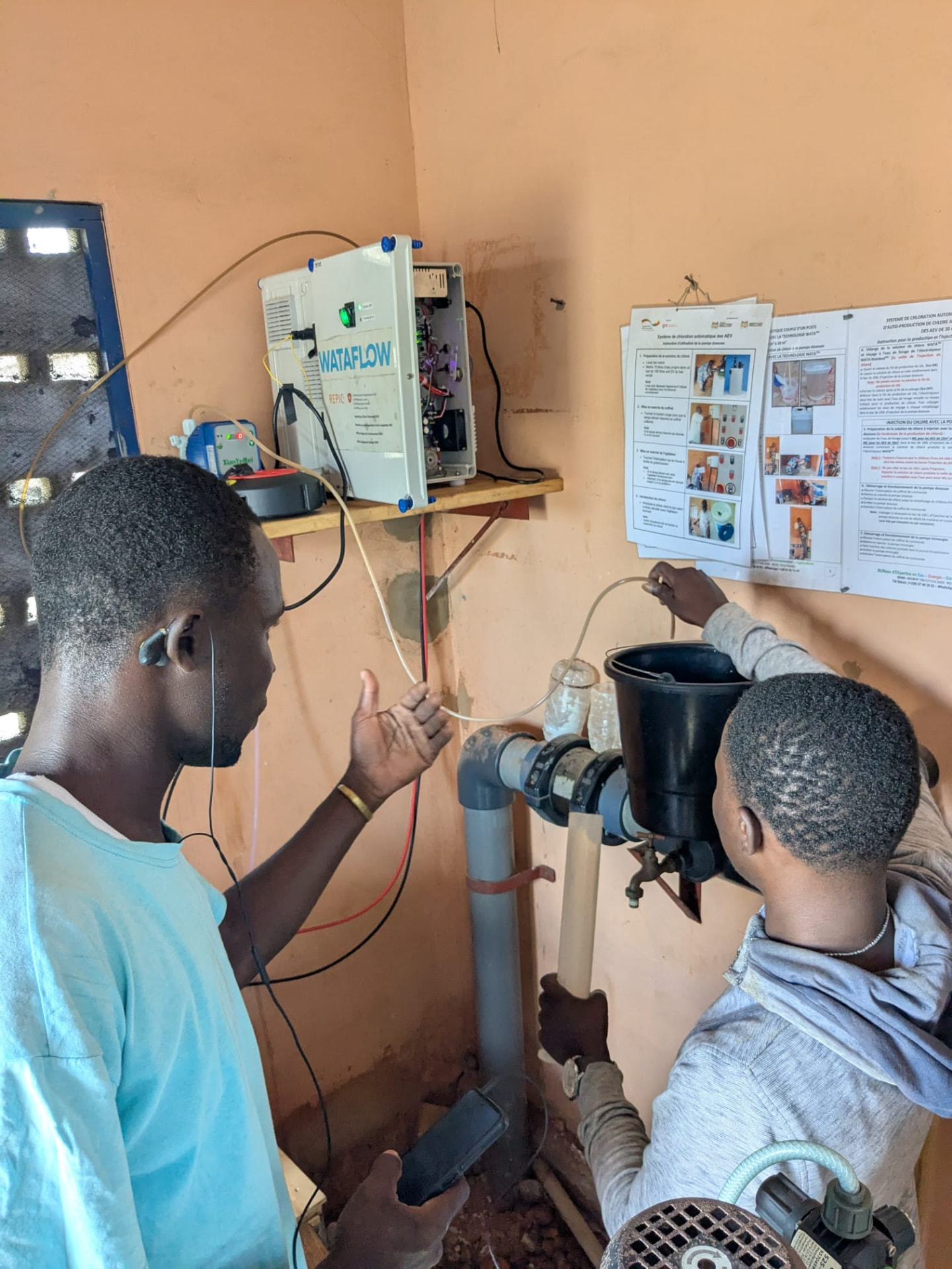 WATALUX technicians commissioning a WATA chlorination and dosing system on a village water network